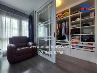 Bedroom with armchair and closet