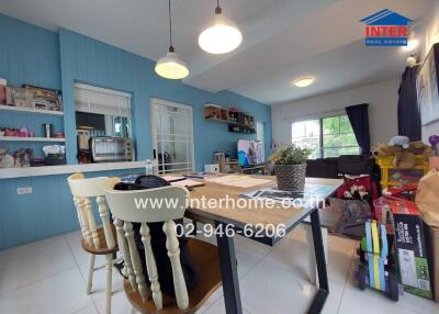 Dining area and kitchen with blue wall and modern decor