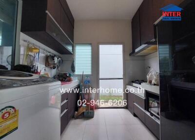 Modern kitchen with dark cabinets and appliances