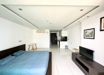 Spacious bedroom with modern furnishings and open kitchenette