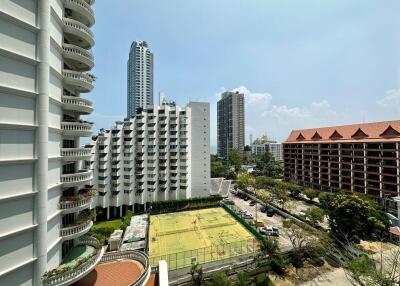 View of multiple buildings with a tennis court