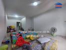 A bedroom with mattresses on the floor and various household items