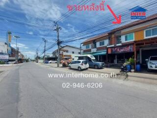 Street view of a commercial area with parked vehicles