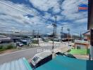 View of street from property with commercial buildings and blue sky