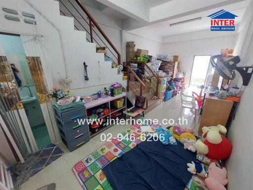 Living area with toys and stairs