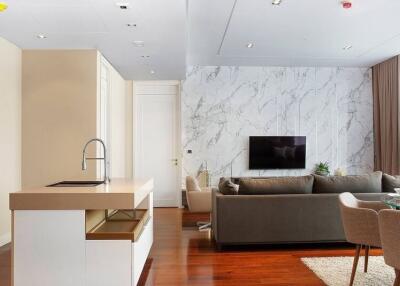 Modern living room with kitchen island and marble accent wall