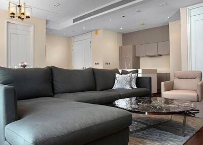 Modern living room with gray sofa, armchair, and marble coffee table