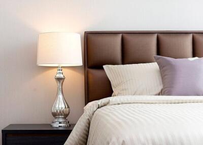 Modern bedroom with lamp, headboard, and pillows
