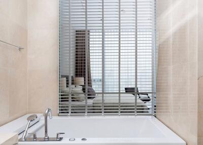 Modern bathroom with bathtub and window blinds