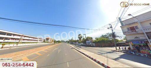 A view of a street with buildings and power lines