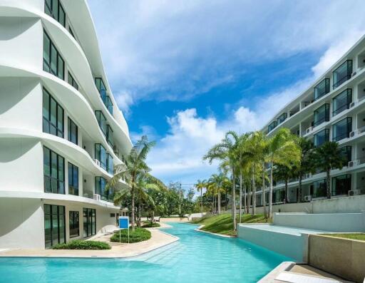 Modern apartment buildings with pool and palm trees