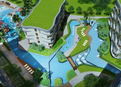 Aerial view of modern apartment complex with pools and green rooftops