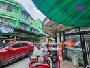 Street view with buildings, cars, and a store entrance