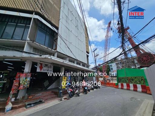 Apartment building exterior with nearby street and construction site