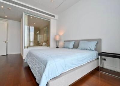 Spacious bedroom with modern decor and view of en-suite bathroom
