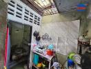 Small kitchen with various utensils and storage shelves