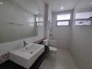 Modern bathroom with sink, toilet, and shower