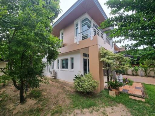 Modern two-story house exterior with garden