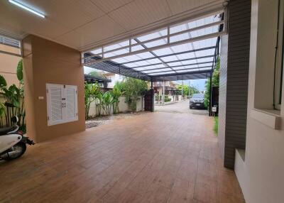 Covered carport with ample space and gate entrance