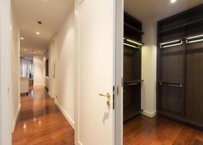 Hallway with wooden flooring and closets