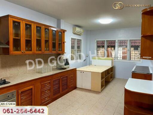 Spacious kitchen with wooden cabinets, tiled countertops, and ample storage space