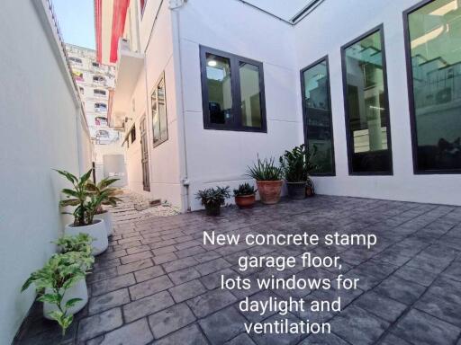 Outdoor area with concrete stamped garage floor and windows for daylight and ventilation