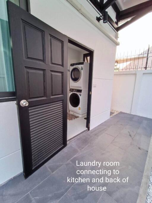 Laundry room connecting to kitchen and back of house