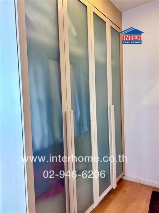 Bedroom with wooden wardrobe and frosted glass doors