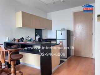 Modern kitchen space with wooden furniture and appliances.