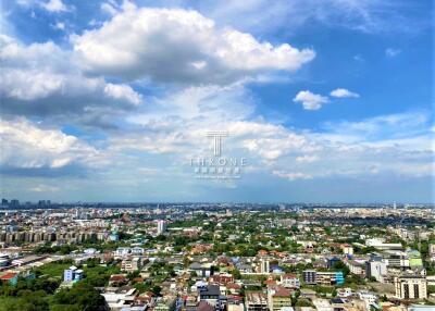 Panoramic view of a city under a partly cloudy sky