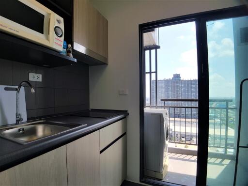 Modern kitchen with appliances and balcony access