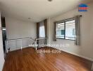 Living area with wooden flooring and windows