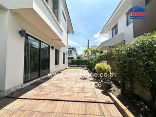 Outdoor patio area of a residential property with neighboring house visible