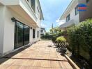 Outdoor patio area of a residential property with neighboring house visible