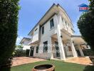 Two-story house with a manicured lawn and patio