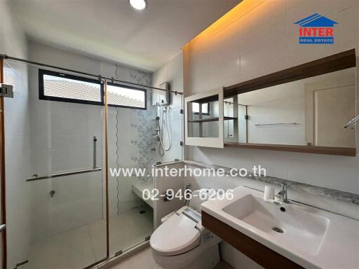 Modern bathroom with shower, toilet, and sink