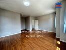 Spacious living area with wooden flooring and natural light