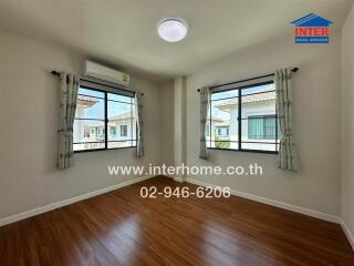 Bedroom with wooden floor and windows