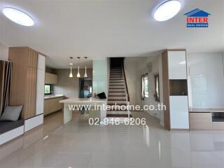 Spacious modern main living area with kitchen and staircase