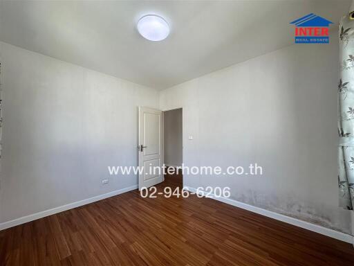 Minimalist bedroom with wooden flooring