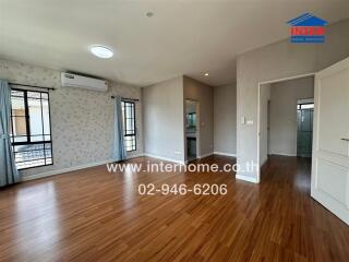 Living room with wooden flooring and air conditioning