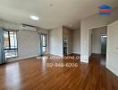 Living room with wooden flooring and air conditioning