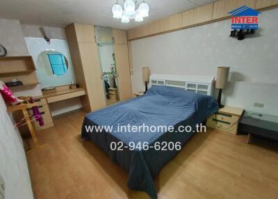 Modern bedroom with wooden flooring and cozy lighting