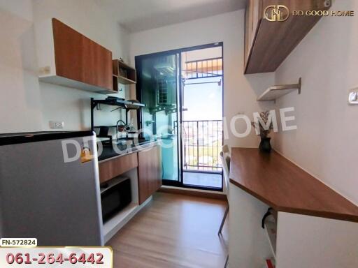 Modern kitchen with wooden countertops, cabinets, and a door leading to a balcony