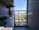 Condo balcony with city view and air conditioning unit