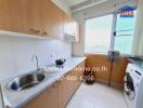 A kitchen with wooden cabinets, a sink, washing machine, and a window.