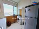 Kitchen with large window, washing machine, and refrigerator