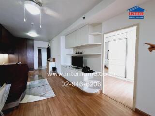 Modern living room with wooden flooring and built-in storage