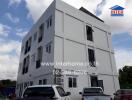 Four-story modern apartment building with several windows