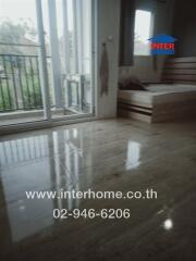 Bedroom with large window and marble floors